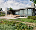 Preview of South Whidbey Residence - Image 4: Building, House, Glass, Wood, Deck, Waterfront, Furniture, Grill, Concrete, Indoor Outdoor, Patio, Yard, Sliding door, Structure steel, Beach.