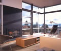 Preview of Stretch House - Image 7: Fireplace, Hearth, Indoors, Interior Design, Door, Sliding Door, Furniture, Reception Desk, Table, Flooring, Hardwood, Wood.