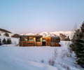 Preview of Sun Valley Fireweed - Image 2: corten, modern architecture, snow landscape, large windows, flat roof, two-story, mountains, mixed materials, natural light, scenic view, rural setting, minimalist design, geometric shapes, outdoor environment.