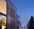 Preview of Sun Valley Fireweed - Image 5: corten, modern architecture, large windows, snow, metal cladding, winter setting, landscape design, exterior lighting, contemporary design, minimalist, natural setting, outdoor space, geometric shapes, evening ambiance.