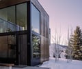 Preview of Sun Valley Fireweed - Image 6: modern architecture, corten, large windows, cantilever, structure concrete, concrete floor, wood ceiling, minimal design, glass facade, winter landscape, rectangular shape, exterior view, sleek design, geometric lines, natural materials, outdoor steps, contemporary house.