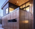 Preview of Sun Valley Fireweed - Image 9: corten, modern architecture, wood ceiling, exterior lighting, glass railing, metal paneling, cantilever, large windows, contemporary design, minimal landscaping, snow, outdoor lighting, facade texture, horizontal siding.