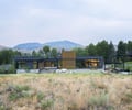 Preview of Sun Valley Fireweed - Image 11: modern house, single-story, flat roof, floor-to-ceiling windows, glass facade, corten, concrete wall, concrete structure, steel structure, outdoor deck, landscape integration, minimalist design, contemporary architecture, open layout, expansive views, nature setting.