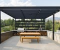 Preview of Sun Valley Fireweed - Image 13: outdoor kitchen, pergola, concrete wall, concrete floor, corten steel, built-in grill, wood storage, countertop, outdoor dining, bench seating, railing, modern design, landscape integration.