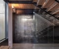 Preview of Sun Valley Fireweed - Image 14: stair, glass railing, structure wood, structure concrete, concrete wall, concrete floor, steel elements, wood ceiling, modern design, industrial style, interior staircase, glass wall, minimalist, architectural lighting, open risers.