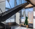 Preview of Sun Valley Fireweed - Image 16: stair, glass railing, concrete floor, wood ceiling, natural light, large windows, modern design, metal structure, entryway, interior architecture, open space, minimalist, wood bench, neutral colors.