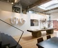Preview of The Gym - Image 1: Plywood, Wood, Dining Table, Furniture, Table, Coffee Table, Dining Room, Indoors, Interior Design, Room, wood floor, stair, structure concrete, lighting, great room, Historic.