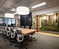 Preview of Undead Labs - Image 12: modern, office, conference, wood table, pendant lighting, glass wall, open space, wood shelving, carpet flooring, nature mural, recessed lighting, office chairs, large windows, interior design.