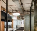 Preview of Undead Labs - Image 2: open floor plan, industrial design, exposed piping, concrete wall, glass partition, track lighting, modern furniture, wood accents, office space, neutral colors, carpet flooring.