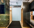 Preview of Undead Labs - Image 14: modern, office, open space, wood paneling, glass partition, exposed ceiling, HVAC ductwork, pendant lighting, textured carpet, color, structure wood, railing.