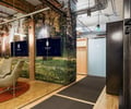 Preview of Undead Labs - Image 17: exposed ductwork, open floor plan, glass partition, office, wood paneling, modern, industrial style, pendant lighting, mixed materials, color, structure wood, railing.