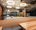 Preview of Undead Labs - Image 16: exposed ceiling, pendant lighting, brick wall, wood flooring, glass partition, open space, structure wood, railing, bench seating, modern, office space, color, conference.