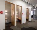 Preview of Undead Labs - Image 18: pivot door, office, interior design, wood, carpet flooring, geometric pattern, modern, frosted glass, neutral colors, lighting, signage.