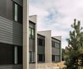 Preview of West Newton Flats - Image 4: Flora, Jar, Plant, Potted Plant, Pottery, Vase, Building, Housing, Outdoors, Yard, Conifer, Tree, Apartment Building, City, High Rise, Town, Urban.
