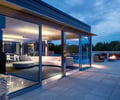 Preview of West Newton Penthouse - Image 11: Couch, Furniture, sliding glass door, paver, firepit, great room, living room, grating.