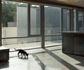 Preview of West Newton Penthouse - Image 7: Bench, concrete floor, grating, bar grating, wood ceiling.