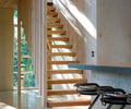 Preview of Wetlands Cabin - Image 10: Handrail, stair, wood floor, wood wall, concrete counter.