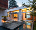 Preview of Windermere Residence - Image 0: Building, House, corten, indoor outdoor, concrete, water feature, fire, fireplace, structure concrete, glass exterior, Corten, Steel, Concrete, Fireplace, Courtyard, Outdoor Indoor, Outdoors, Water Feature, Flora, Wood, Glass, Window, Glass Door.