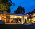 Preview of Windermere Residence - Image 4: House, Housing, steel frame, glass exterior, corten, lighting, planting, Structure Steel, Steel, Corten, Concrete, Outdoors, Yard, Patio, Glass, Glass Door, Cantilever, Window, Flora, Water Feature.