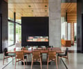Preview of Windermere Residence - Image 7: Dining Table, Indoors, Cafe, Dining Room, Interior Design, concrete floor, structure steel, structure concrete, cedar, wood ceiling, Wood, Glass, Steel, Window, Fireplace, Concrete, Pillar.