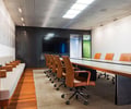 Preview of Zillow Executive Offices - Image 15: Chair, Furniture, Conference Room, Meeting Room, Room, Table, Electronics, leather, grating, wood floor, concrete table, steel black, TV, pivot door.