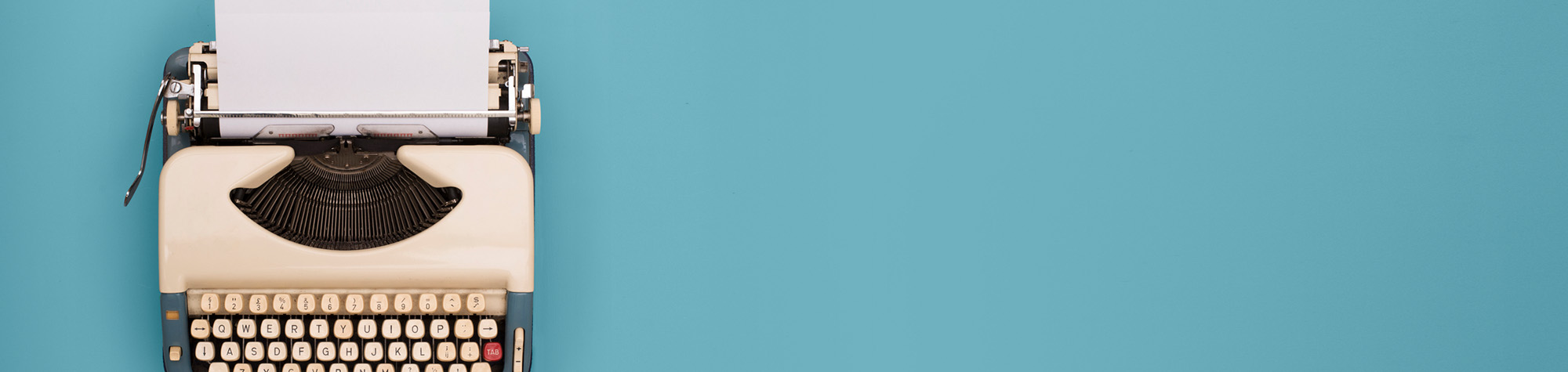 Typewriter on blue background - 7 Rules of Writing.