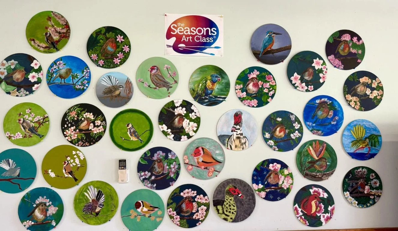 A wall of student artwork from Seasons Art Class