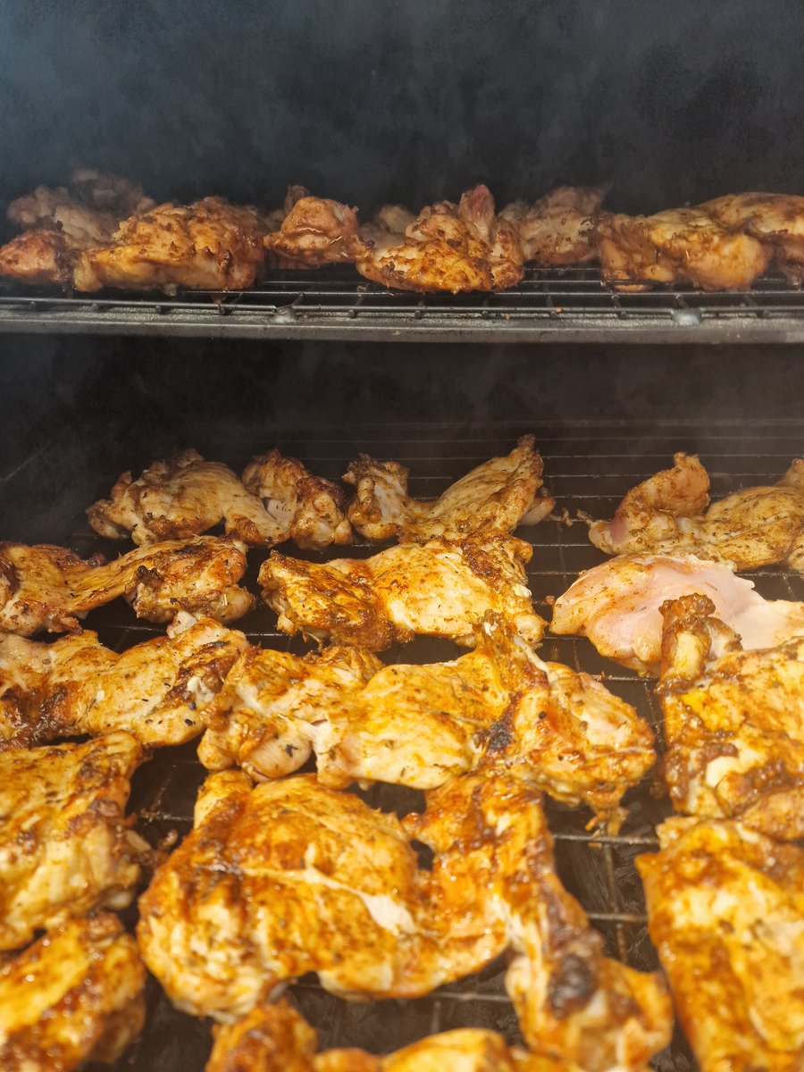 Marinated chicken pieces cooking on a grill, ready for a delicious BBQ feast