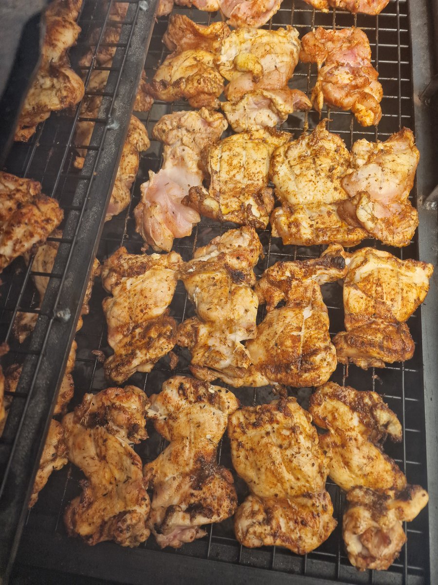 Succulent chicken pieces, seasoned and chargrilled to perfection on a BBQ grill, ready for a delicious outdoor catering event