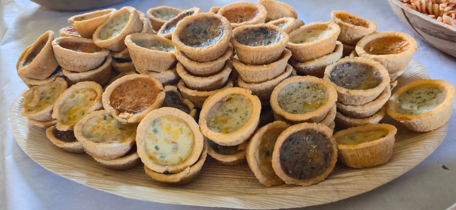 A selection of mini quiches with various fillings, perfect for a buffet or canapé reception