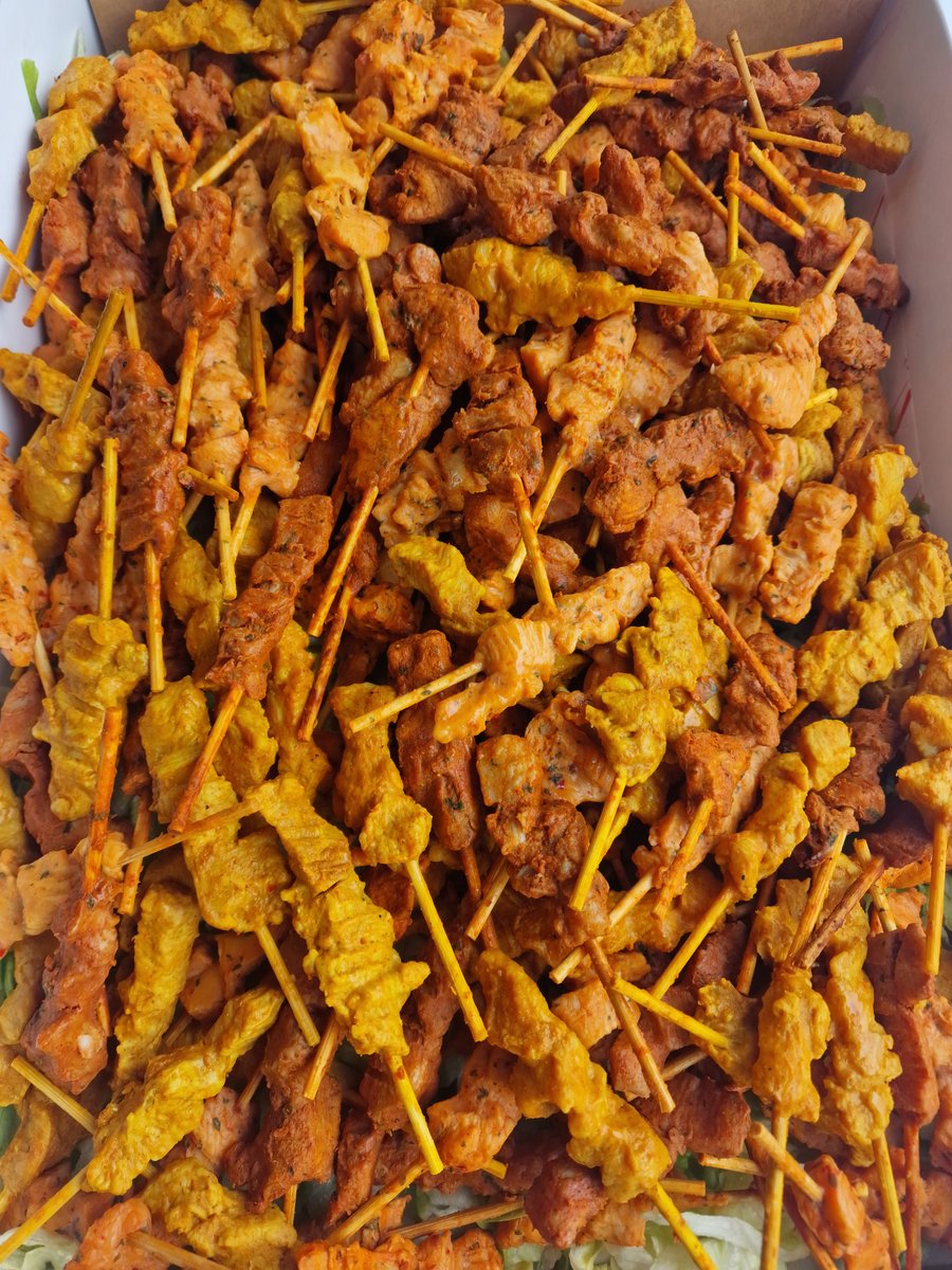 A vibrant selection of chicken satay skewers, perfect for a buffet or canapé reception