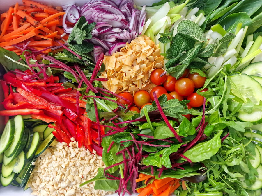 A vibrant, fresh salad with a variety of colourful vegetables and garnishes