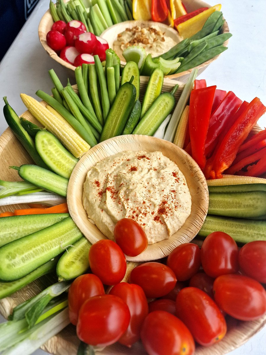 Platters of fresh, colourful crudités with hummus are artfully arranged for a healthy appetizer