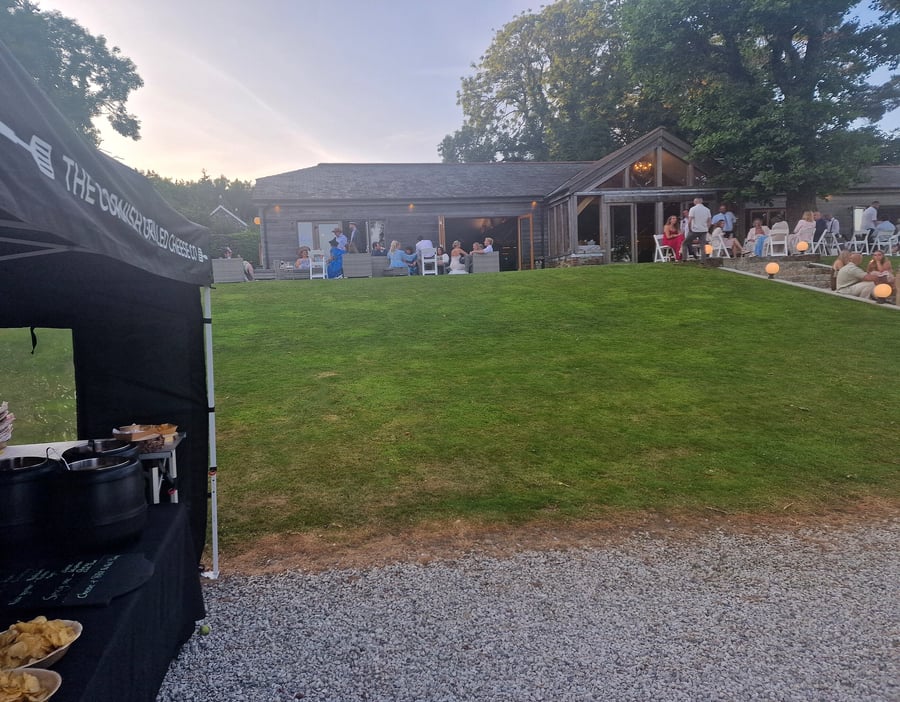 Outdoor event catering tent set up with food service near a venue