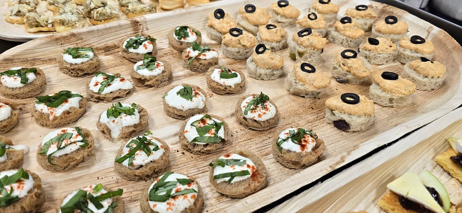 Assortment of canapés and finger foods artfully arranged on wooden platters