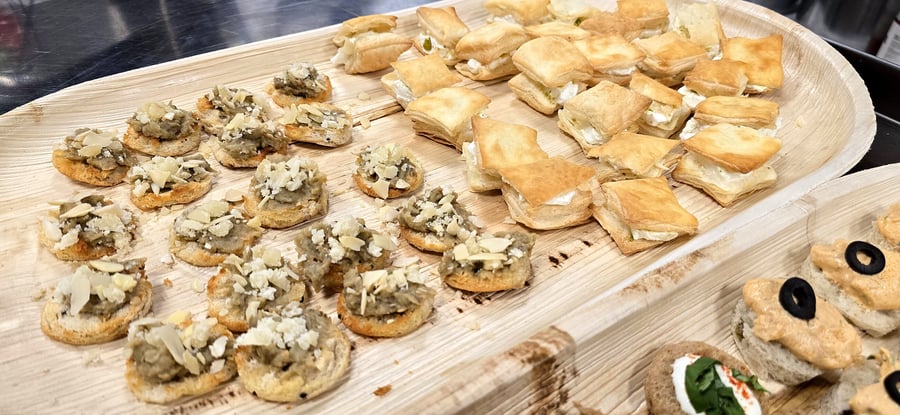 Assortment of elegant canapés served on natural palm leaf platters