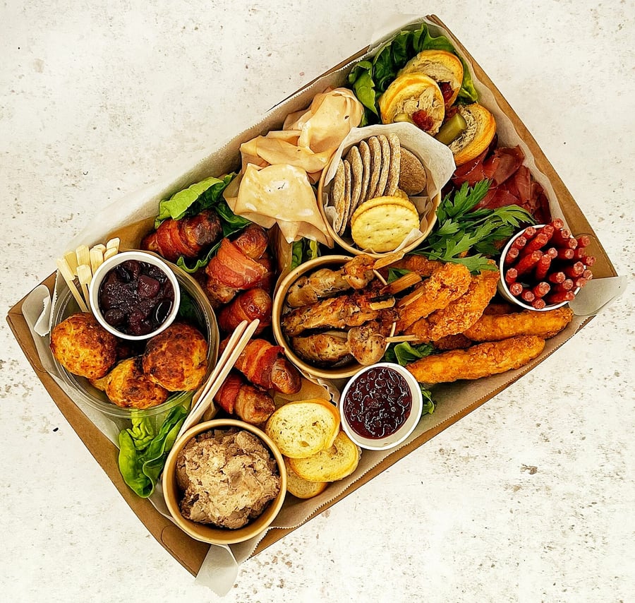 A delicious platter box filled with various snacks and dips, perfect for events