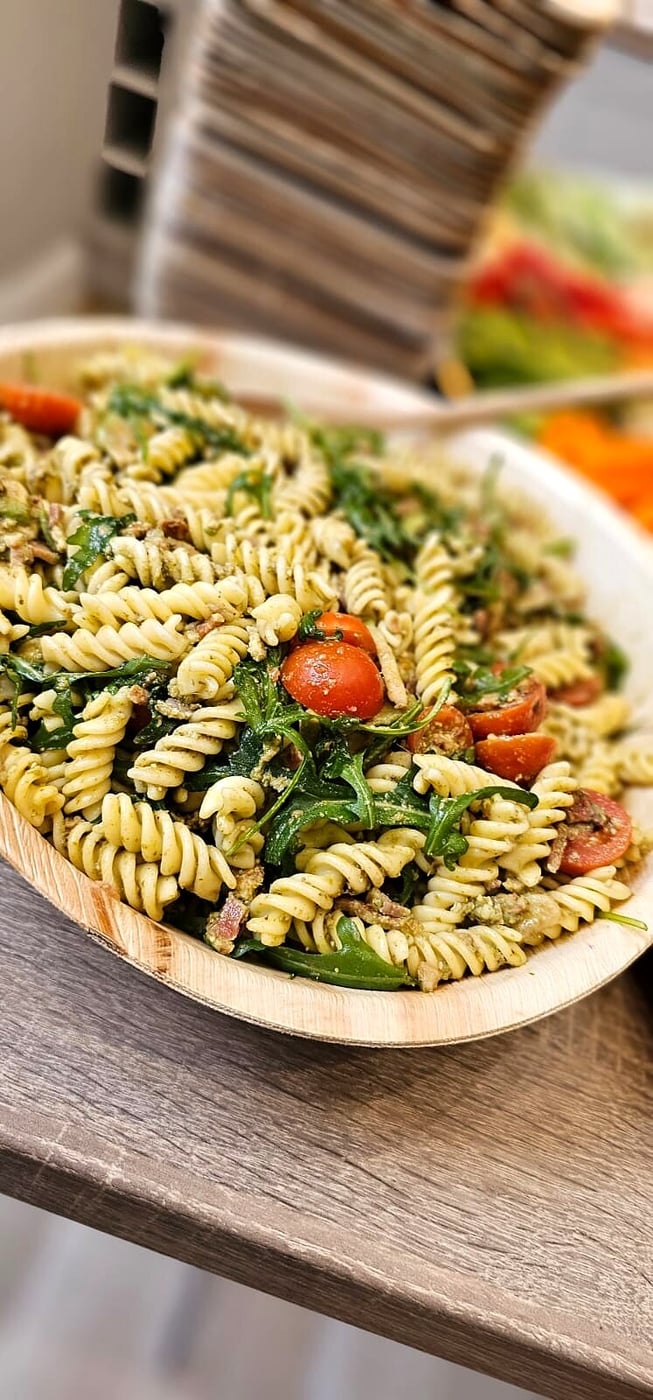 A close-up of a delicious pasta salad with cherry tomatoes and rocket