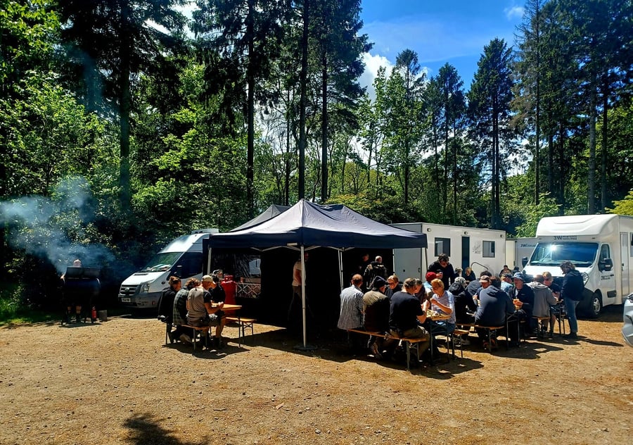 Catering provided for a film crew in a forest setting with outdoor seating