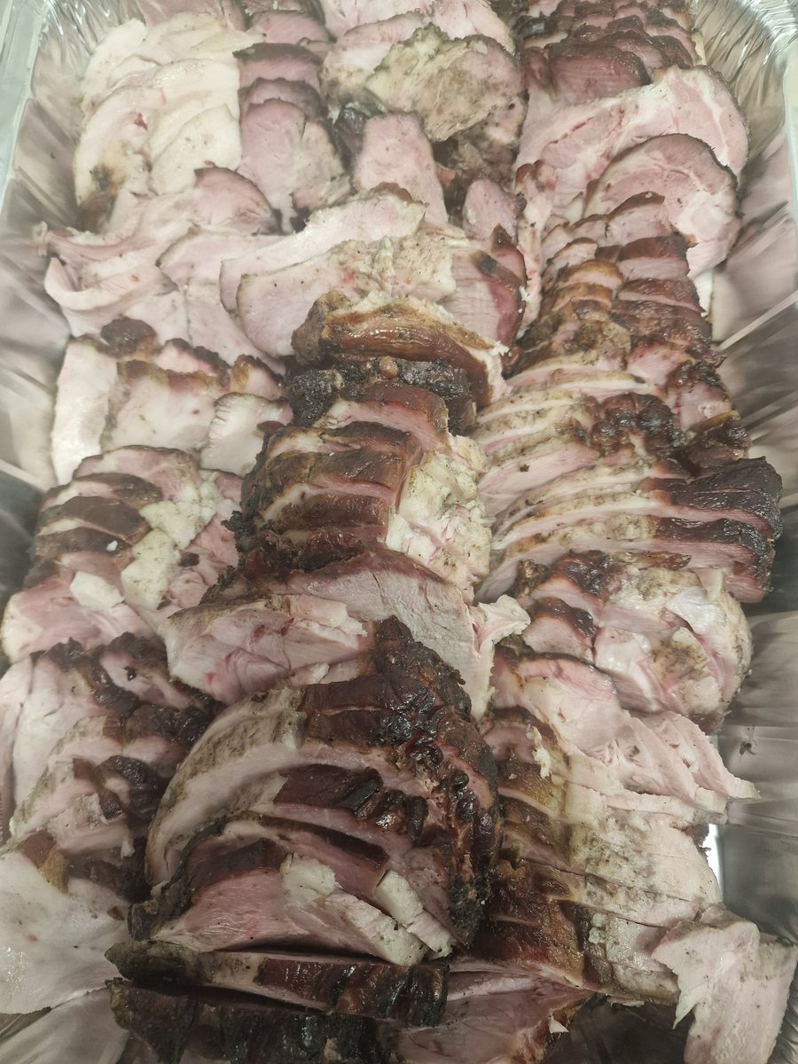Succulent slices of slow-roasted hog, perfectly carved and ready to serve for your event