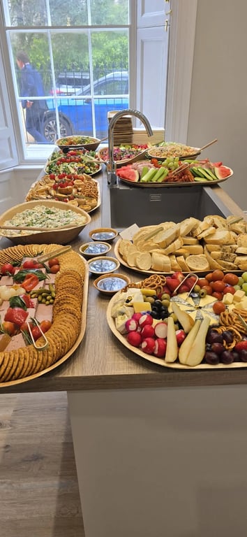 Buffet table laid with platters of Cornish meats, cheeses, salads and sandwiches at a Salt Wind Catering event
