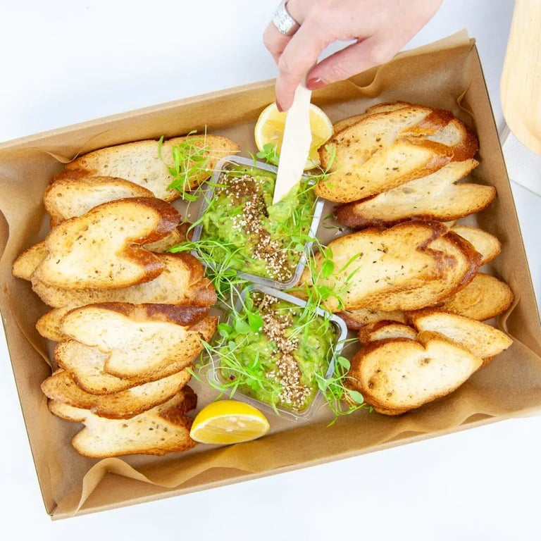Smashed avocado toast box by Salt Wind Catering