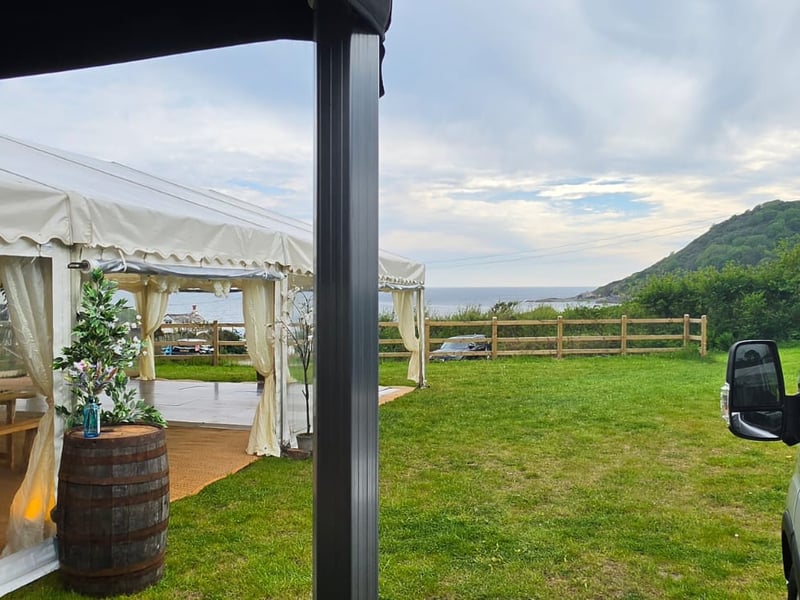 Wedding catering in Cornwall — marquee with coastal view