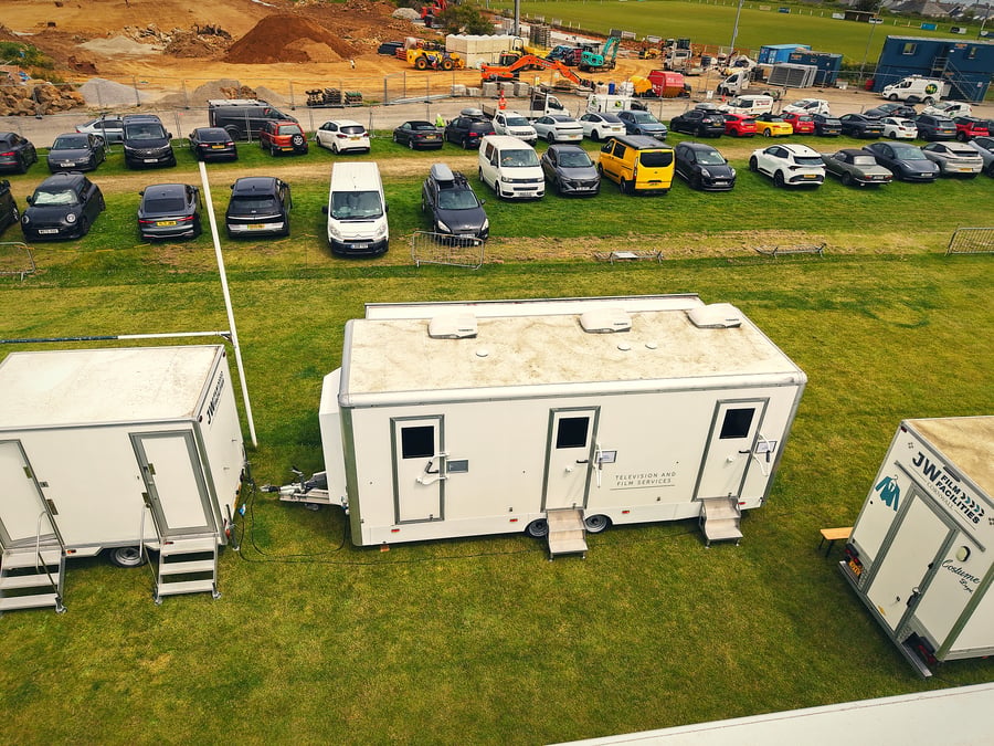 An aerial view of a film and TV production unit base with welfare facilities and crew vehicles