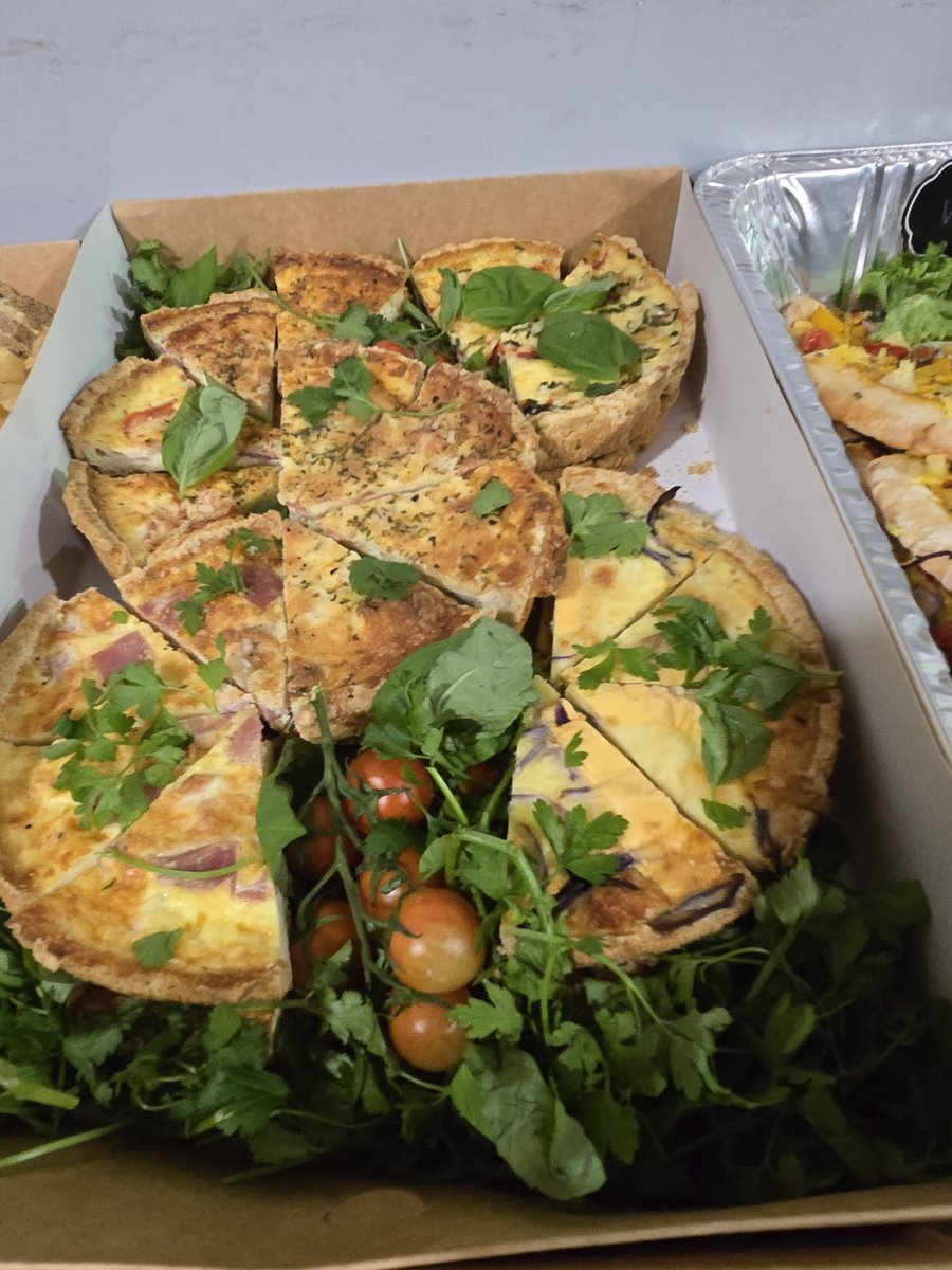Assortment of freshly prepared quiches and tarts served with fresh garnishes