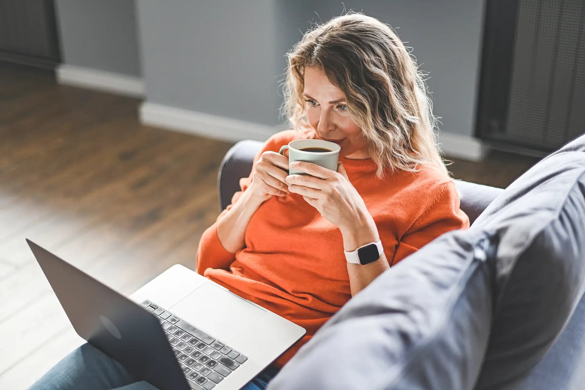 Woman smiling during an online perimenopause care appointment