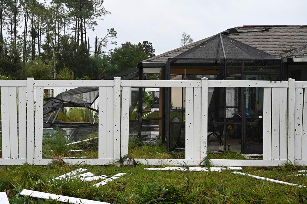 A side fence and the backyard of a house on Bayside Drive, where the tornado appeared to have torn through one backyard after another, sparing the homes themselves of most of the damage. (© FlaglerLive)