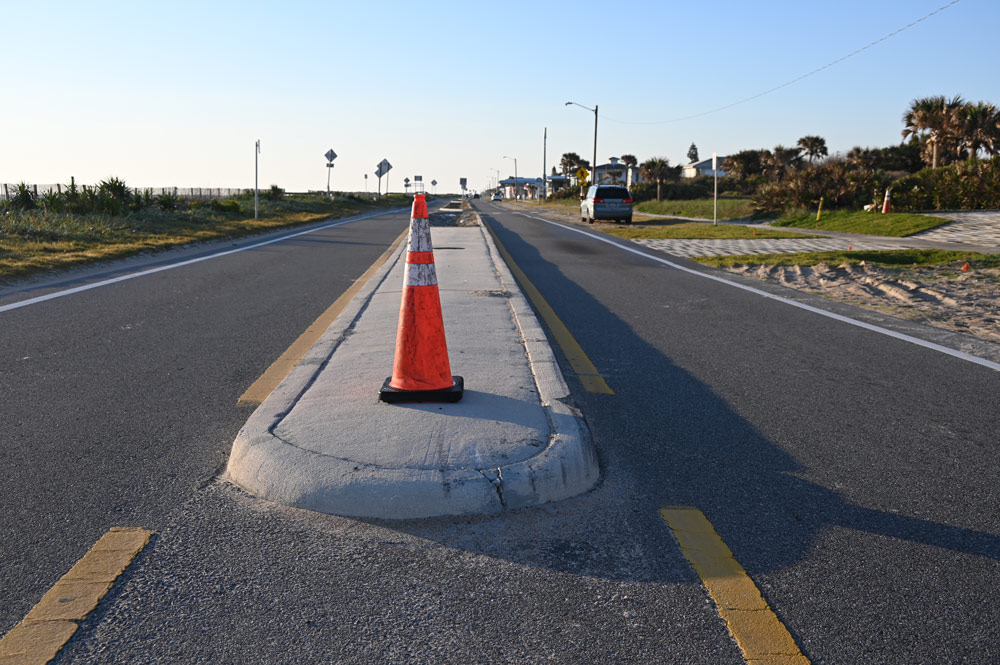 The concrete median that divides State Road A1A starts at South 9th Street, where the motorcyclist attempted to pass an SUV on the left, striking the median and overturning. (© FlaglerLive)