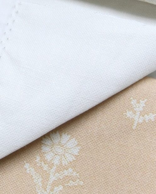 A photo of heavy french linen with a printed design on it that shows the woven fabric texture