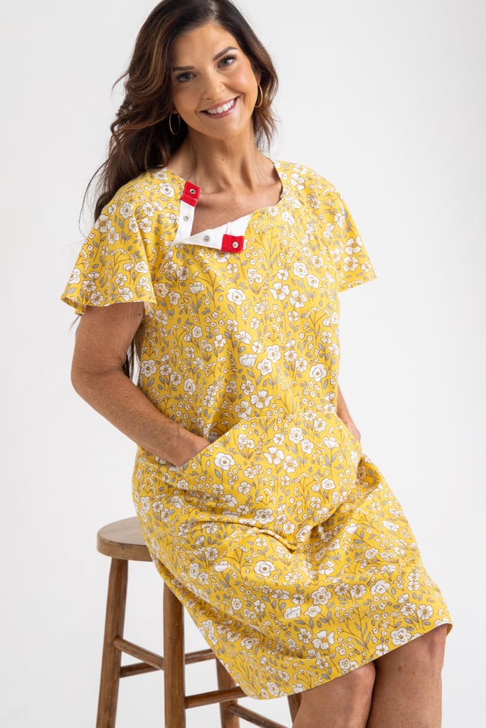 a pregnant lady wearing a navy and olive floral gown from untethered